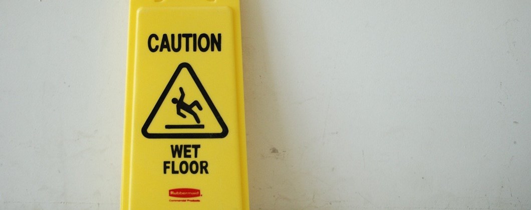 Wet floor sign showing the need for Employers’ Liability Insurance